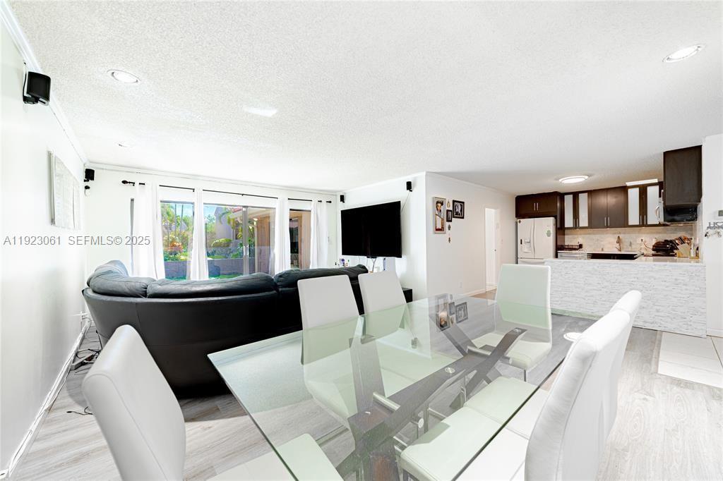 402 St Andrews Road, Unit 55 Hollywood, FL 33021 - Photo 6 of 14 a living room with furniture and a flat screen tv