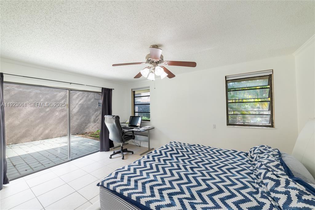 402 St Andrews Road, Unit 55 Hollywood, FL 33021 - Photo 8 of 14 a bedroom with a bed and wooden floor