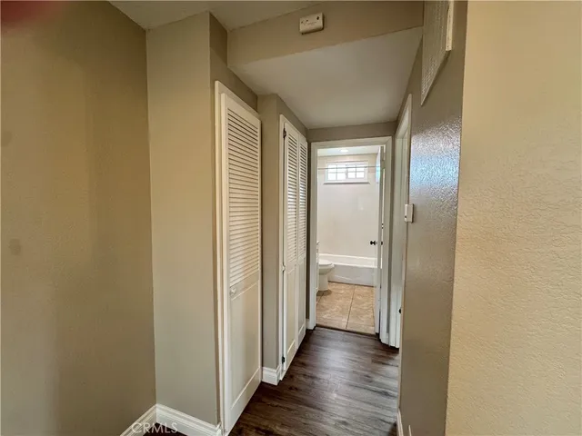 a view of a hallway with wooden floor