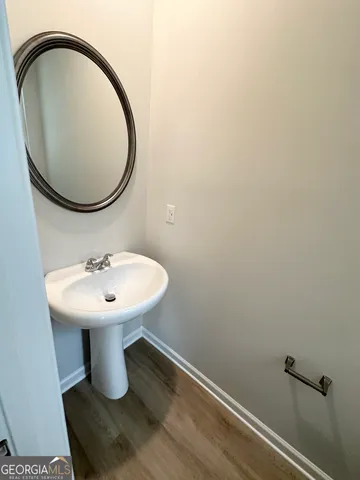 a bathroom with a sink a mirror and toilet