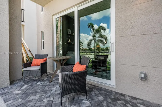 a outdoor space with patio couch and a potted plant