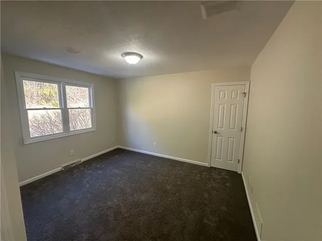 a spacious bathroom with a granite countertop sink and a mirror