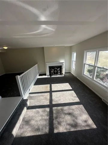 a view of an empty room with windows