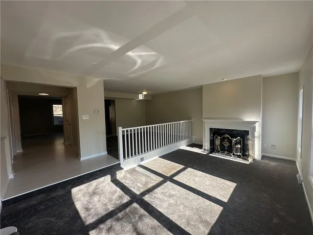 wooden floor with a fireplace in living room