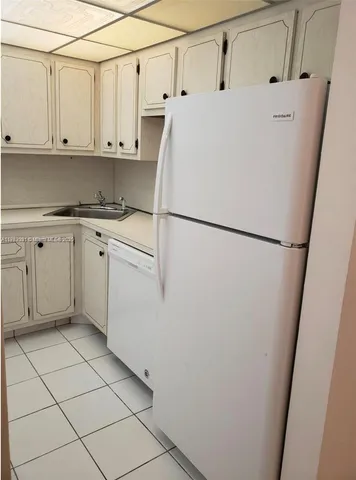 a white refrigerator freezer sitting inside of a kitchen