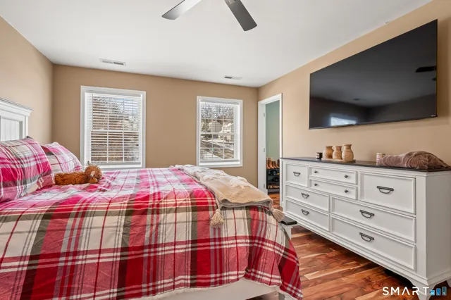 a bedroom with a bed and a flat screen tv