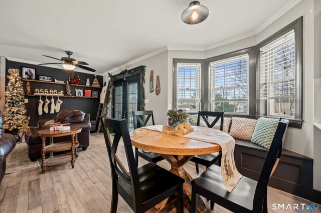 a dining room with furniture and wooden floor