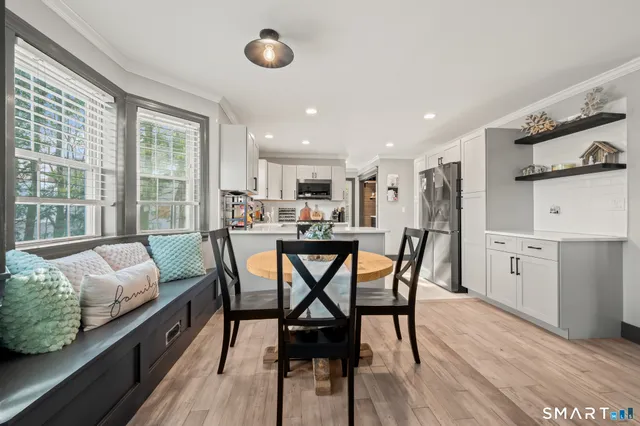 a kitchen with a sink a counter top space stainless steel appliances and cabinets