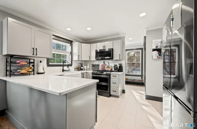 a kitchen with a sink stove and cabinets