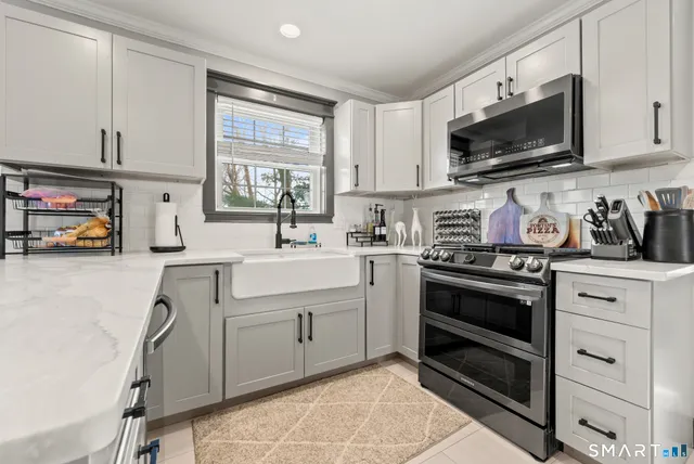 a kitchen with a sink stove oven and cabinets
