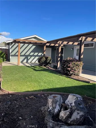 a view of a yard with wooden fence
