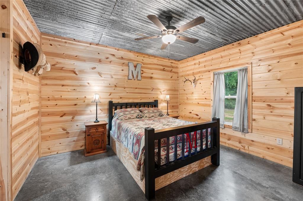 3815 Fm 2088 Quitman, TX 75783 - Photo 9 of 24 a bedroom with a bed and a flat tv screen