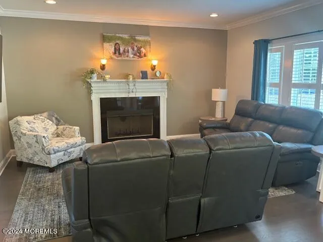 a view of a room with window wooden floor and front door