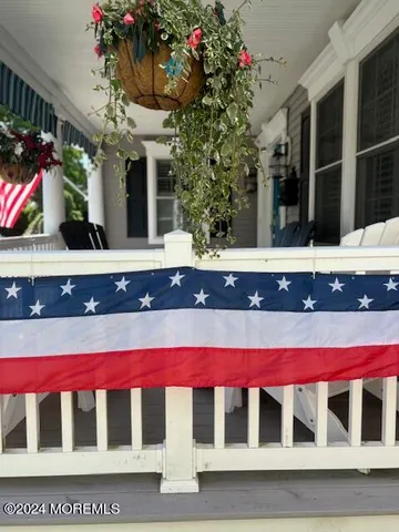 a view of a patio with table and chairs under an umbrella