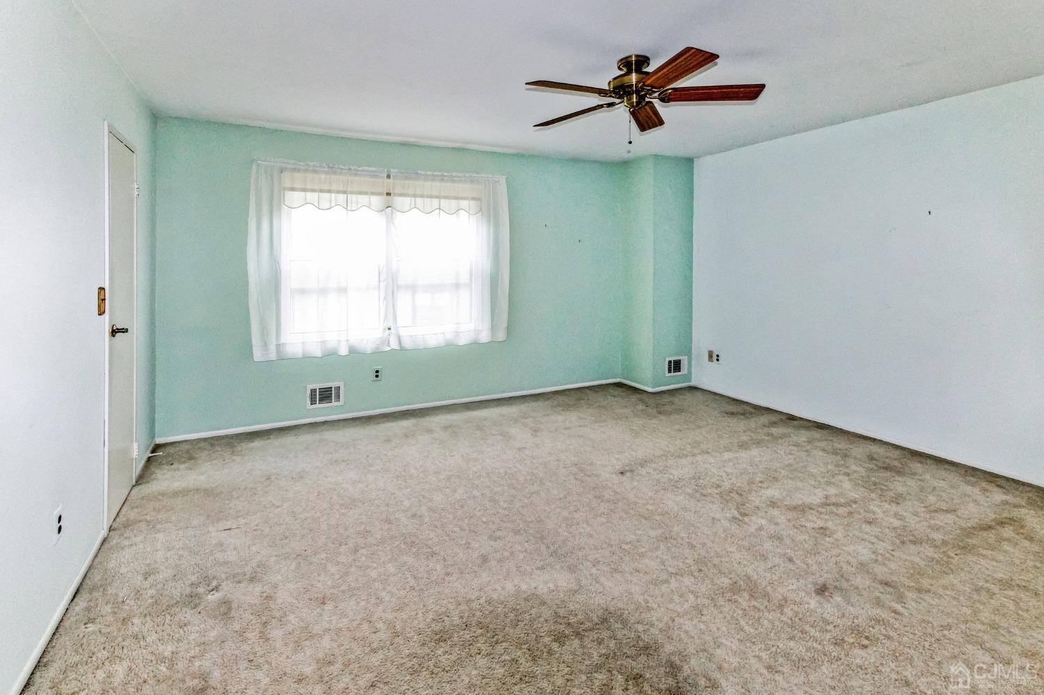 7301 Hana Road Edison, NJ 08817 - Photo 20 of 34 a view of room with window and ceiling fan