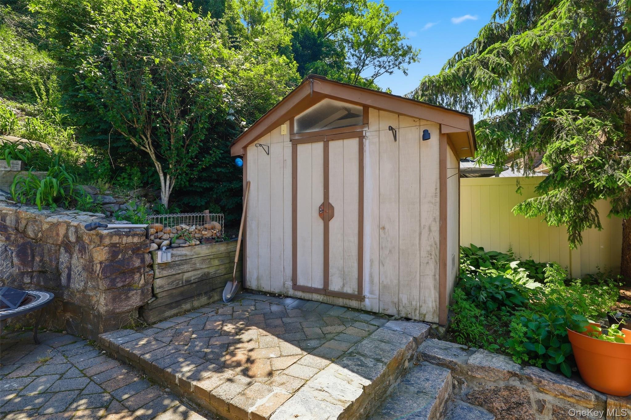 29 Montrose Road Yonkers, NY 10710 - Photo 31 of 39 Exterior storage shed with a peaked roof, set on a paver patio