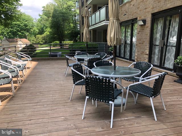 1600 Hagys Ford Road, Unit 5M Penn Valley, PA 19072 - Photo 17 of 18 a roof deck with table and chairs and potted plants