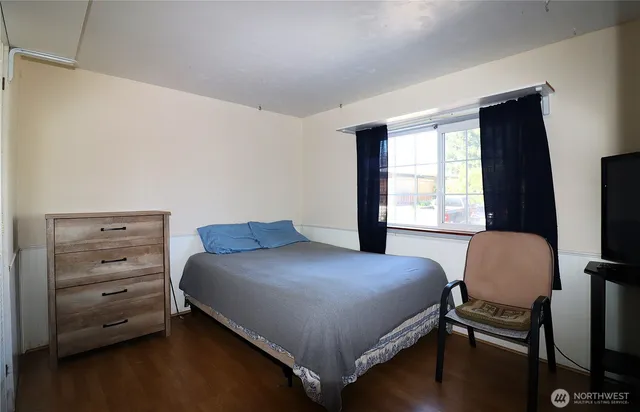 a bedroom with a bed and a chair