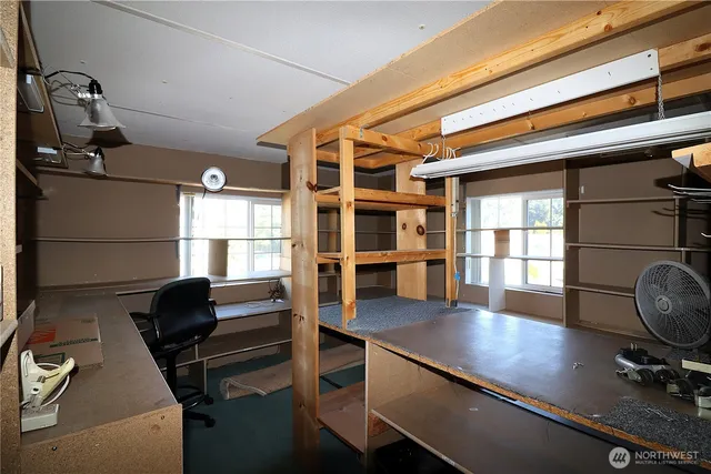a view of workspace with wooden floor and windows