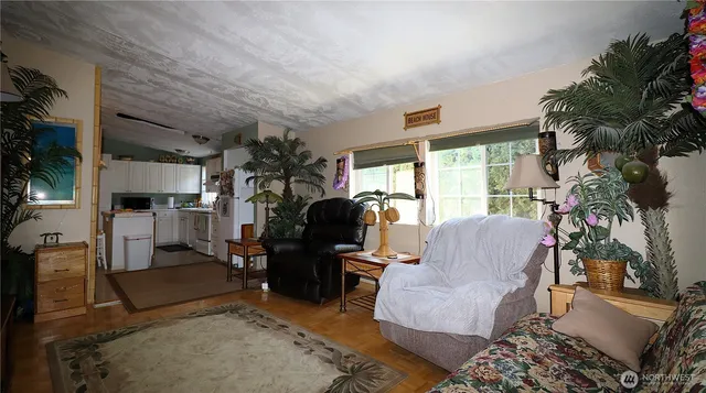 a living room with furniture and a potted plant