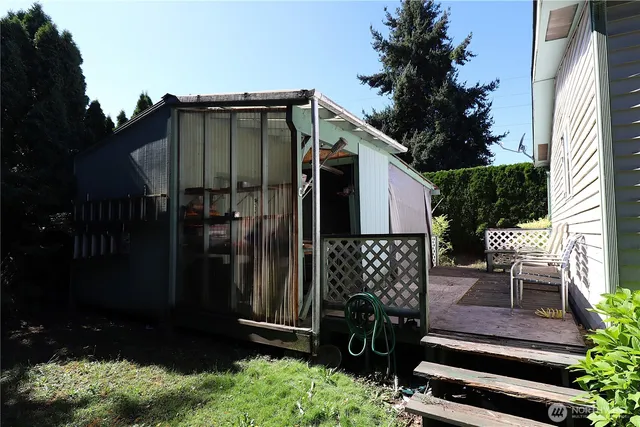 a view of a chair and table in the backyard