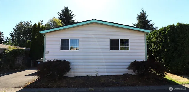 a backyard of a house with wooden floor and outdoor seating