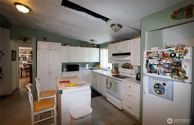 a kitchen with refrigerator a stove a microwave and a refrigerator