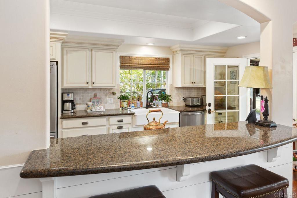 3433 Royal Road Vista, CA 92084 - Photo 14 of 45 a kitchen with granite countertop a sink stainless steel appliances and cabinets