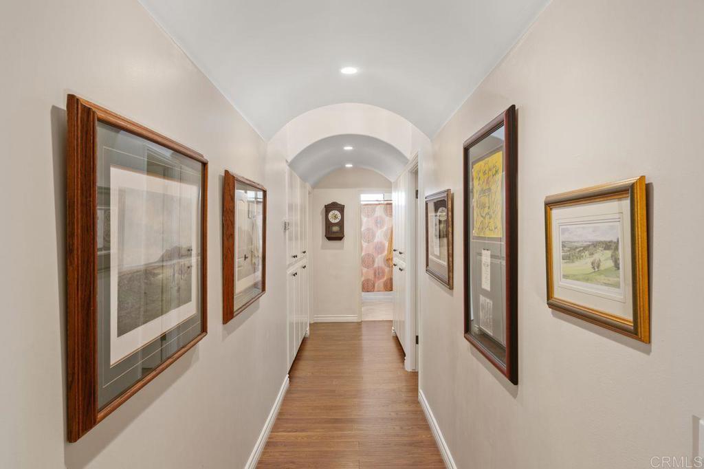 3433 Royal Road Vista, CA 92084 - Photo 19 of 45 a view of a hallway with wooden floor and glass door