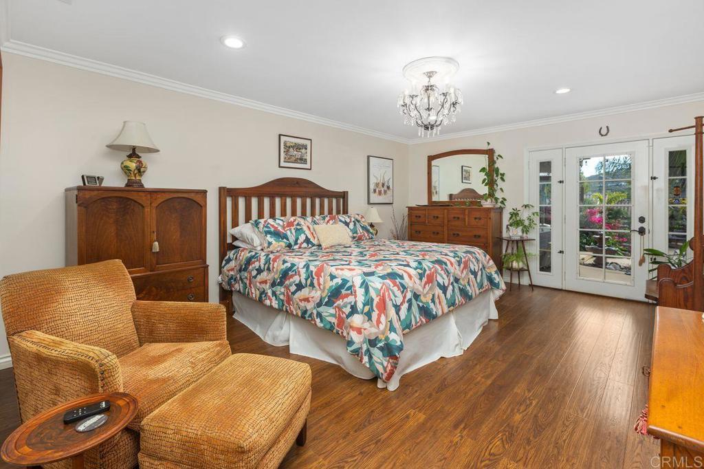 3433 Royal Road Vista, CA 92084 - Photo 20 of 45 a bedroom with a bed and chandelier