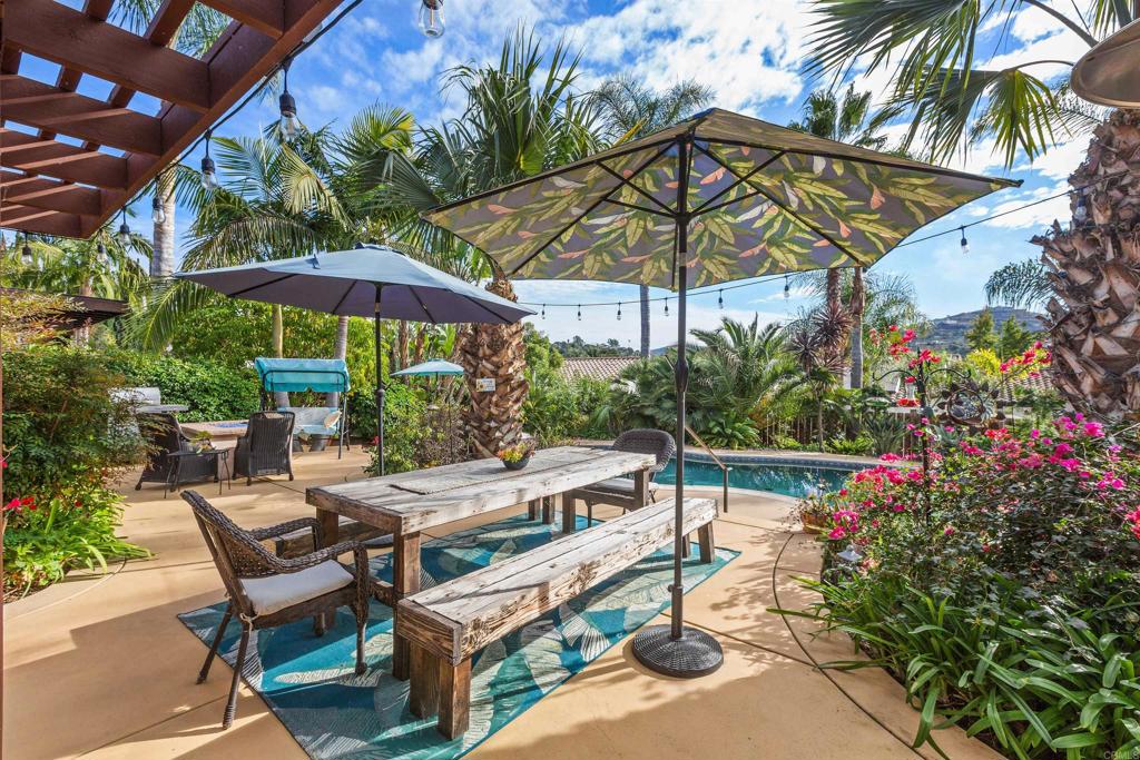 3433 Royal Road Vista, CA 92084 - Photo 2 of 45 a view of patio with chairs and table under an umbrella with a barbeque