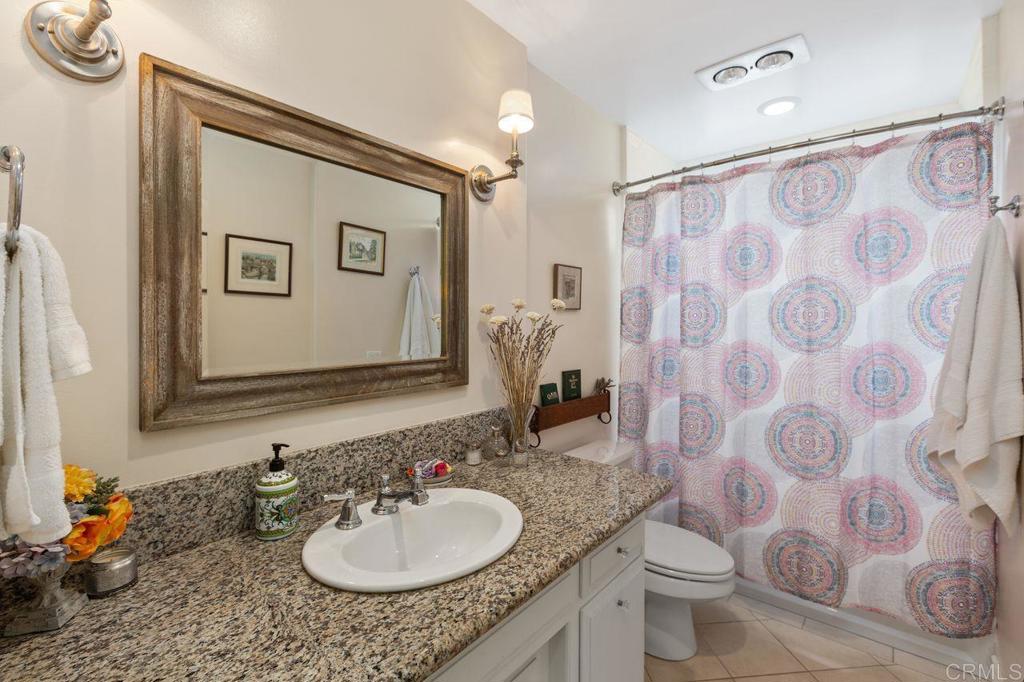 3433 Royal Road Vista, CA 92084 - Photo 26 of 45 a bathroom with a granite countertop sink and a mirror
