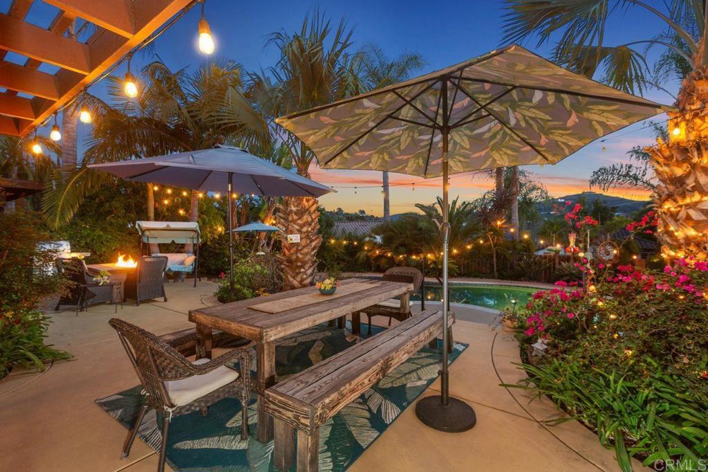 3433 Royal Road Vista, CA 92084 - Photo 31 of 45 a view of a patio with a table and chairs under an umbrella