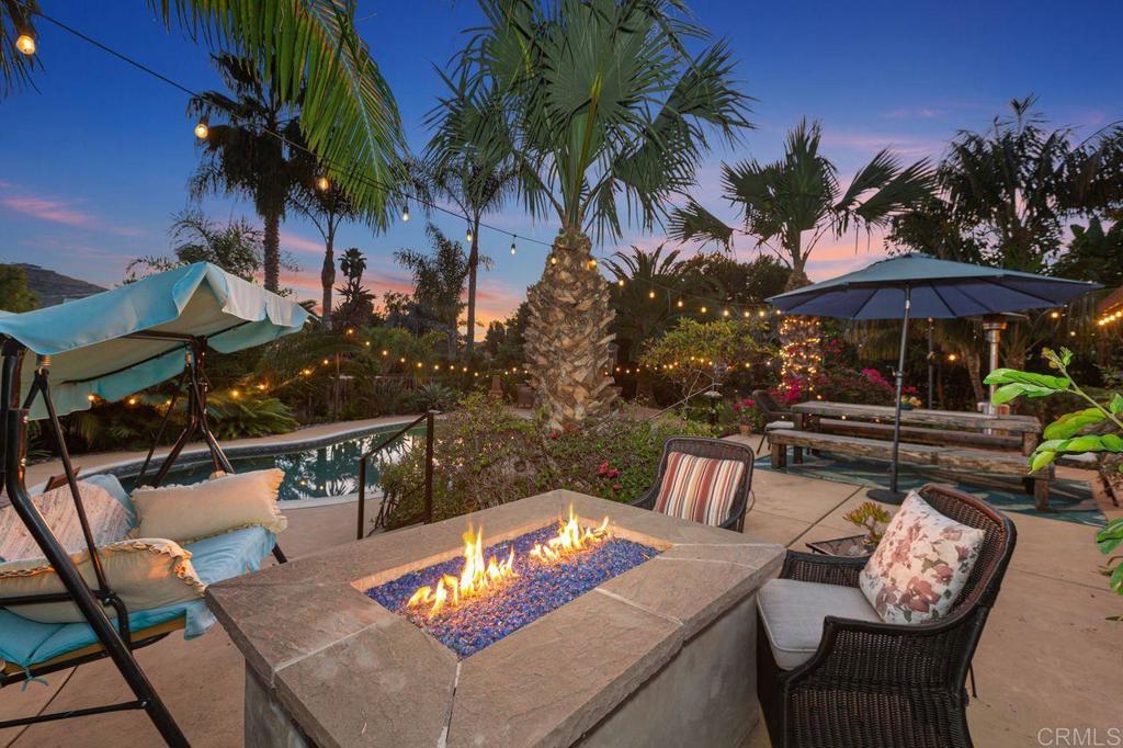 3433 Royal Road Vista, CA 92084 - Photo 34 of 45 a view of an outdoor sitting area with furniture and umbrella