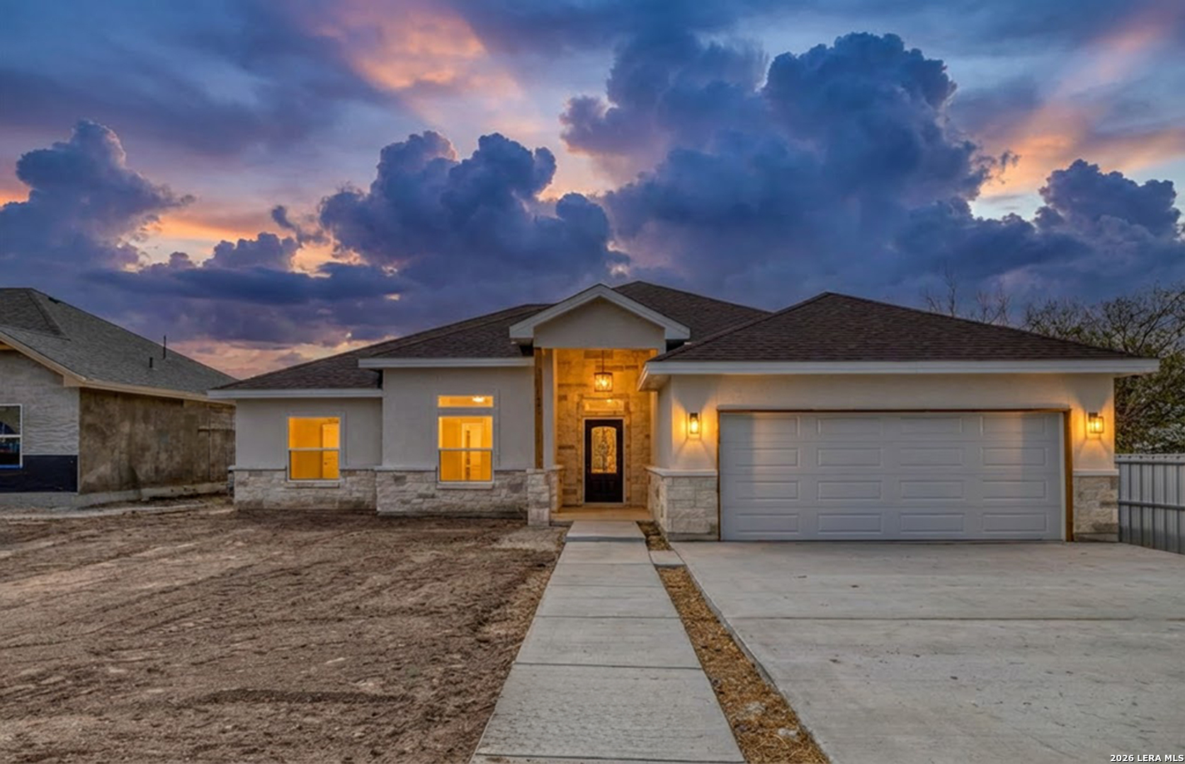 207 Riverside Drive Uvalde, TX 78801 - Photo 1 of 37 a front view of a house with a yard and garage