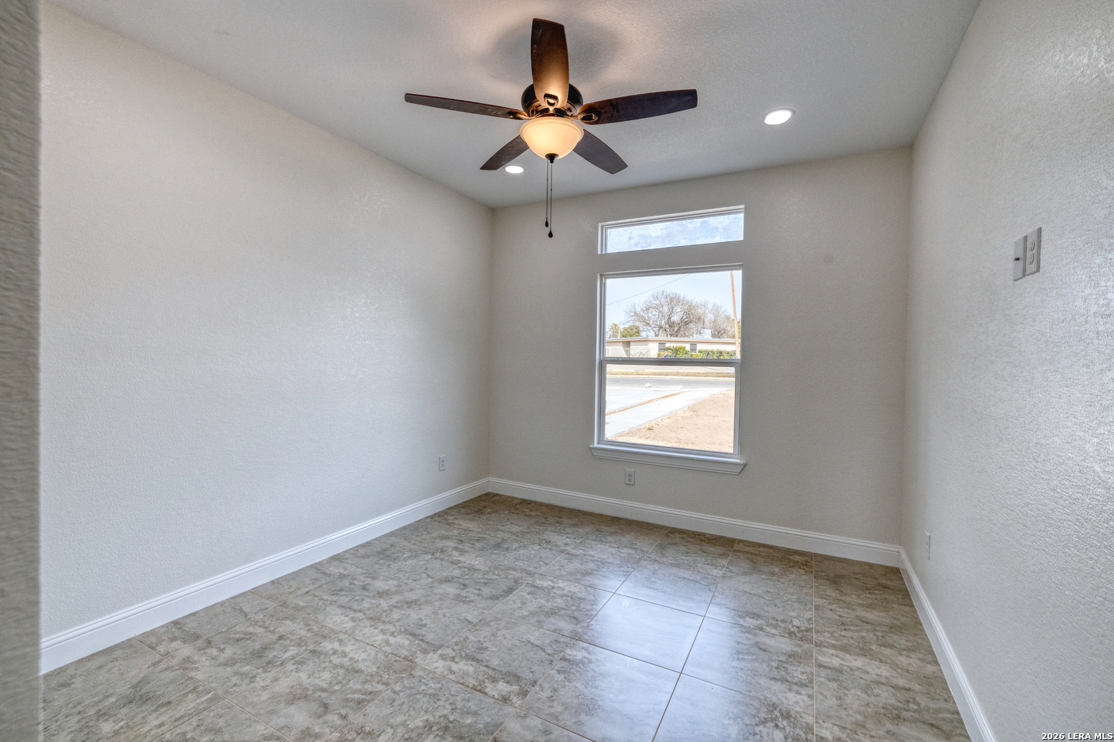 207 Riverside Drive Uvalde, TX 78801 - Photo 21 of 37 wooden floor in an empty room with a window