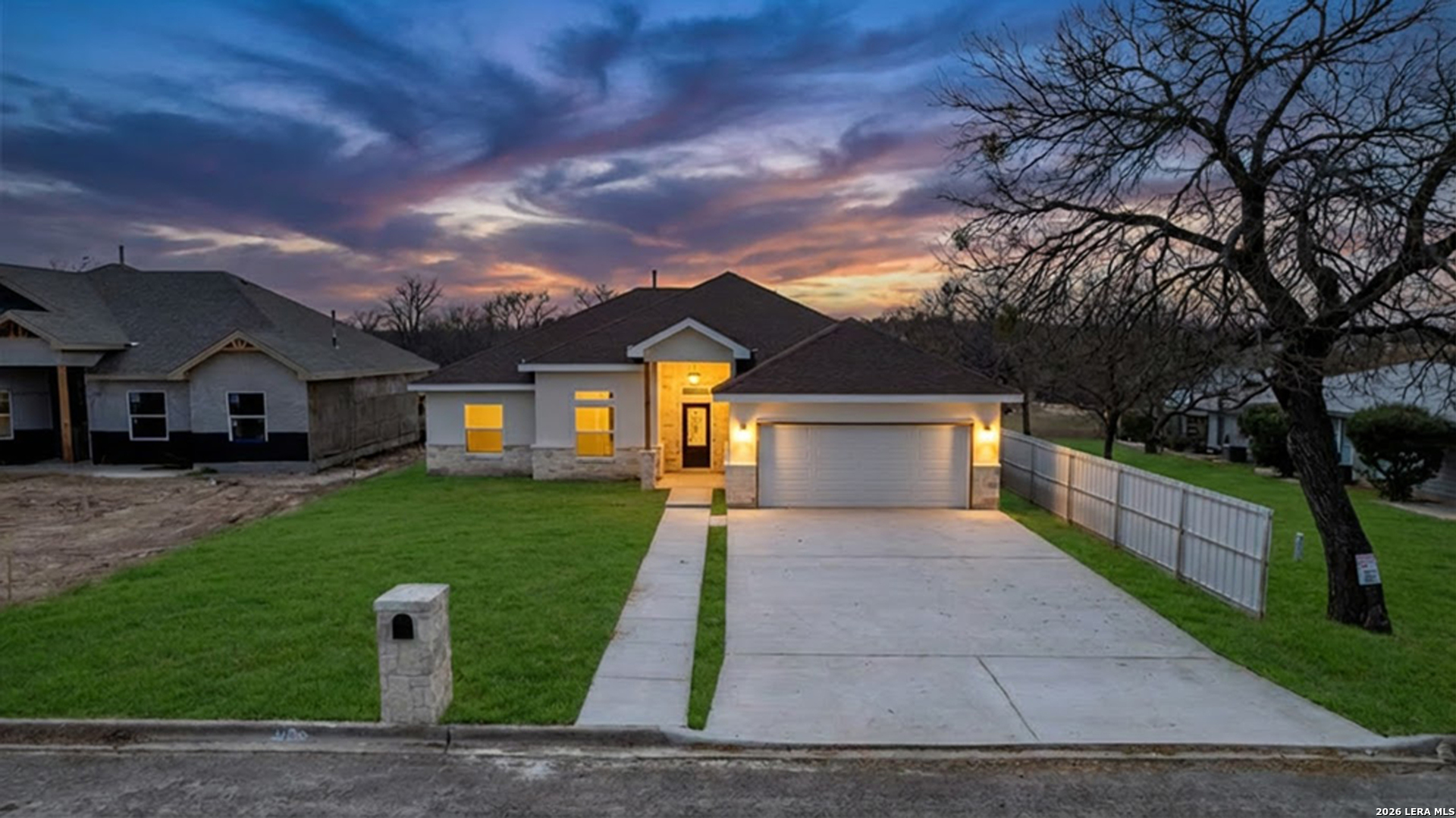 207 Riverside Drive Uvalde, TX 78801 - Photo 34 of 37 a front view of a house with a yard and garage