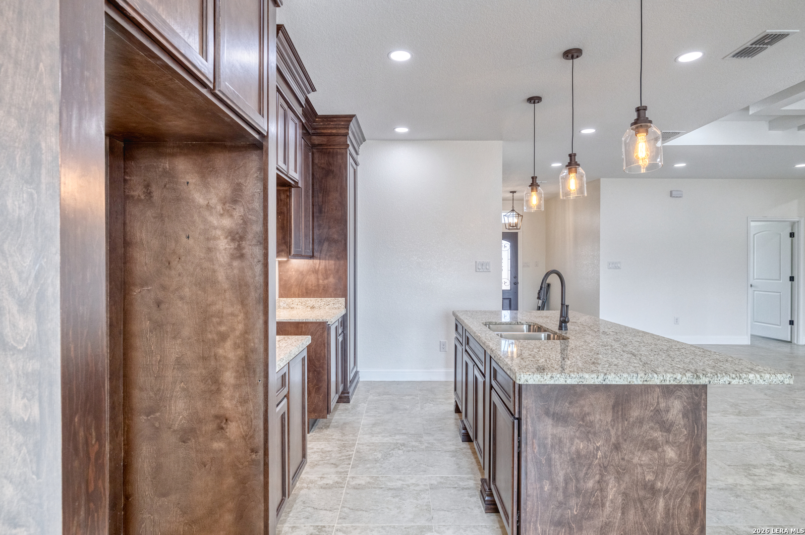 207 Riverside Drive Uvalde, TX 78801 - Photo 10 of 37 a bathroom with a granite countertop sink a large mirror and shower