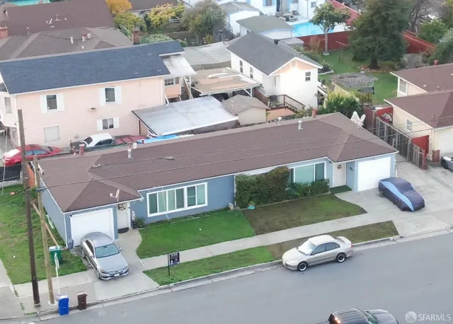 an aerial view of multiple houses with a yard