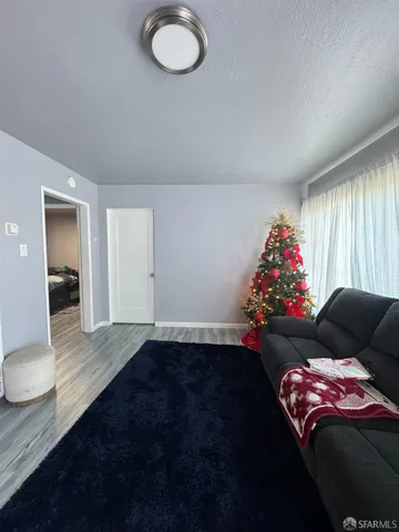 a bedroom with furniture and a floor to ceiling window