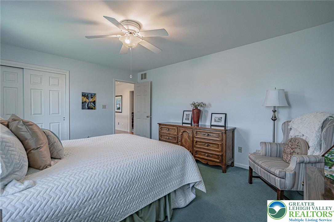 4542 Springfield Drive Coplay, PA 18037 - Photo 46 of 89 Relax in this tranquil bedroom, featuring soft carpeting and a classic ceiling fan for ultimate comfort.