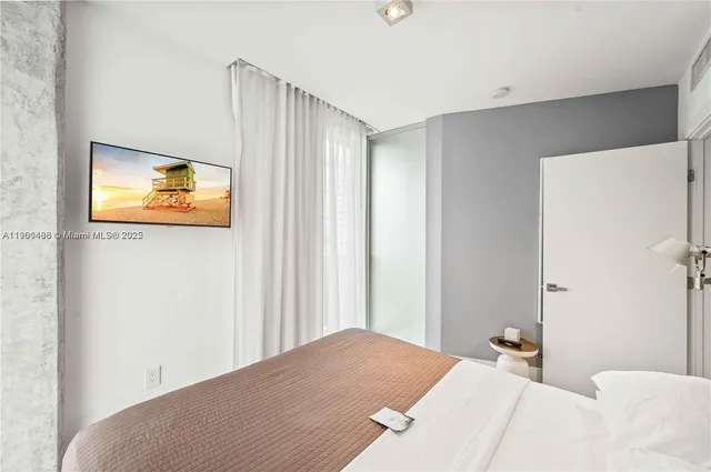 a bedroom with a bed and a painting on the wall