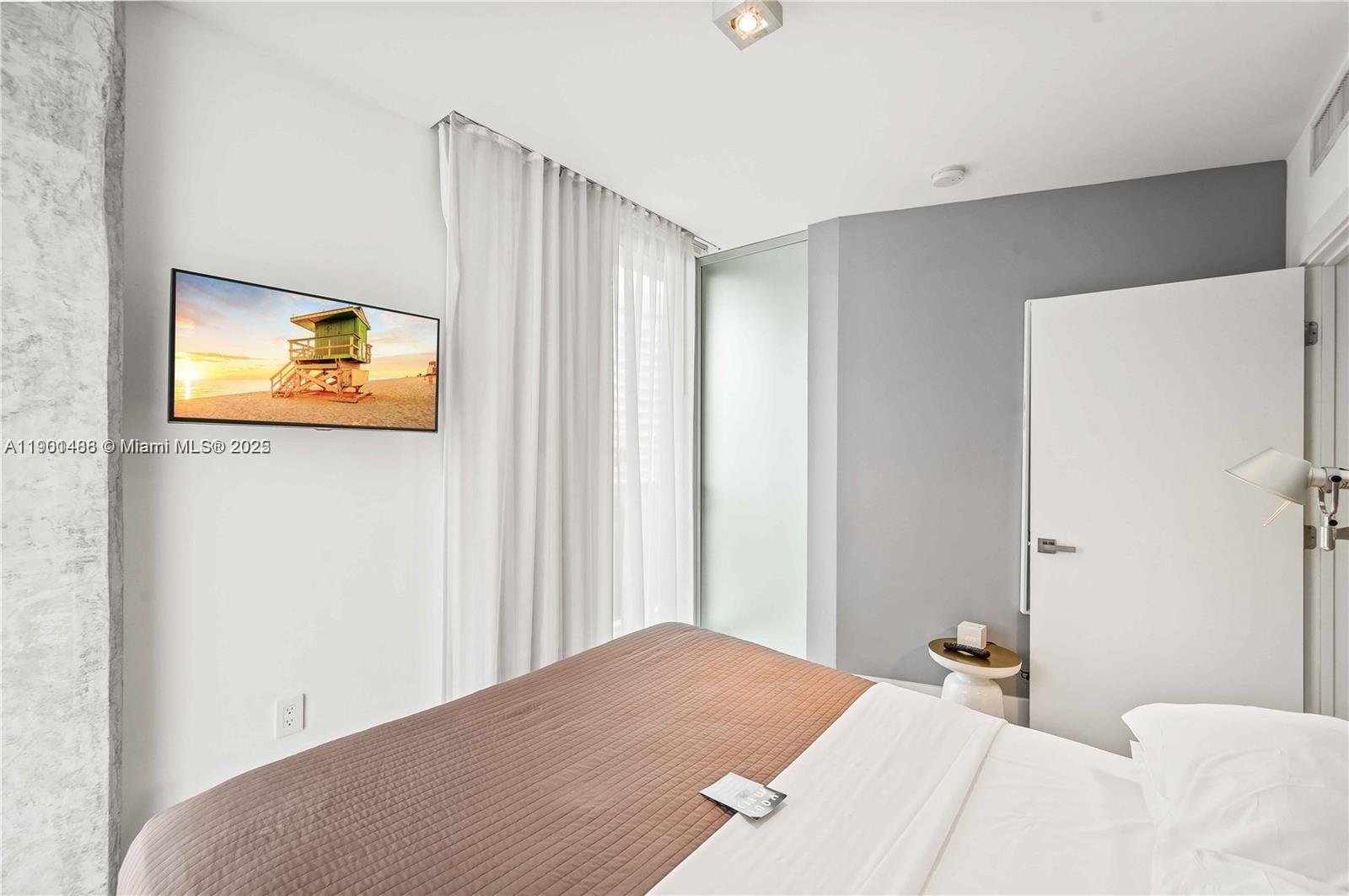 1215 West Avenue, Unit 605 Miami Beach, FL 33139 - Photo 11 of 19 a bedroom with a bed and a painting on the wall