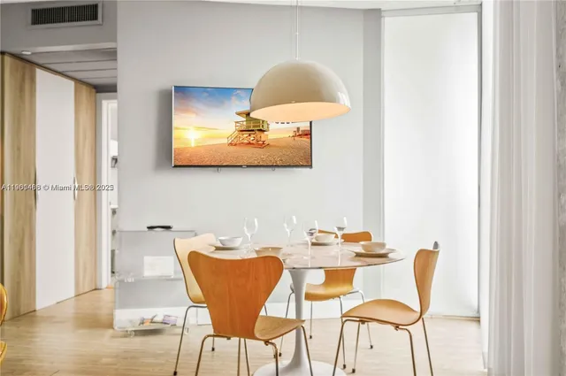 a dining room with furniture and wooden floor