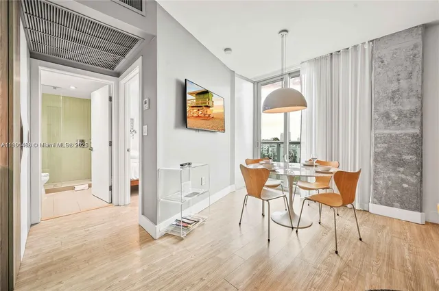 a dining room with furniture and window