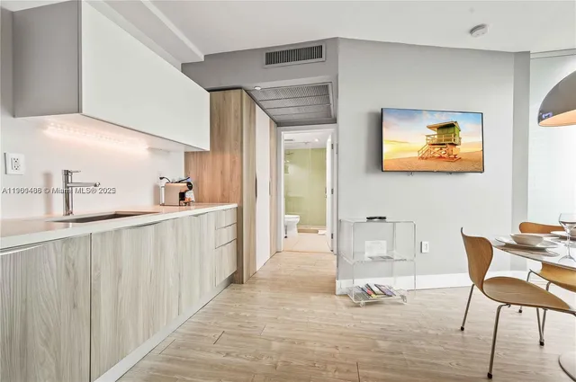 a view of a hallway with furniture and windows