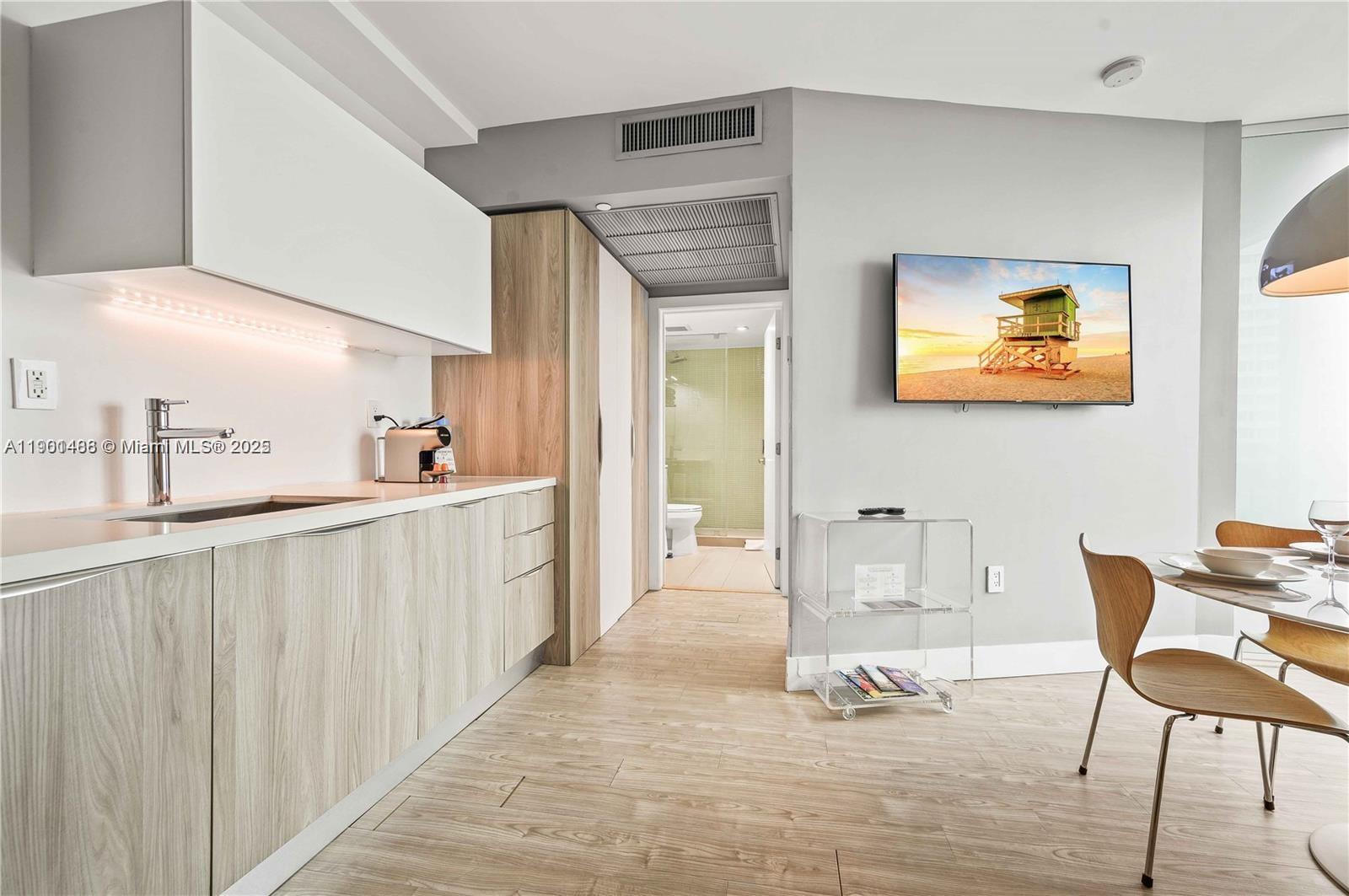 1215 West Avenue, Unit 605 Miami Beach, FL 33139 - Photo 8 of 19 a view of a hallway with furniture and windows