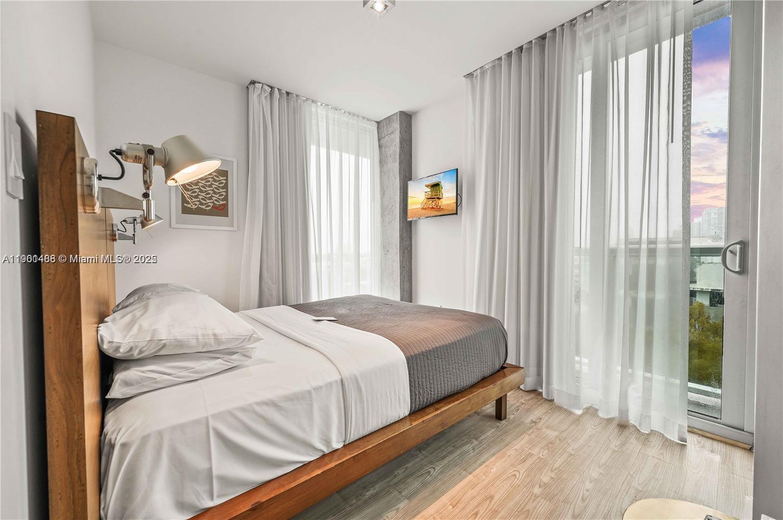 1215 West Avenue, Unit 605 Miami Beach, FL 33139 - Photo 9 of 19 a bedroom with a bed and a window