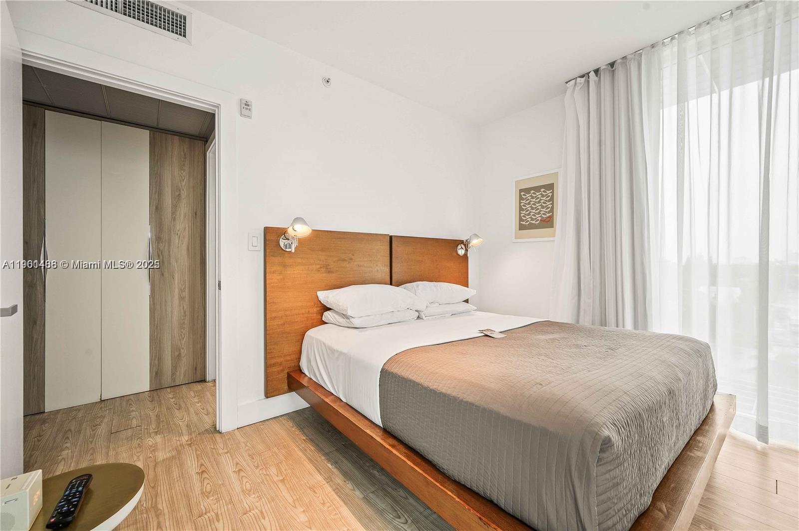 1215 West Avenue, Unit 605 Miami Beach, FL 33139 - Photo 10 of 19 a bedroom with a bed and a cabinets