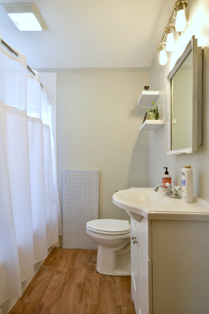 7625 Monroe Street Forest Park, IL 60130 - Photo 6 of 52 a bathroom with a sink toilet and a mirror